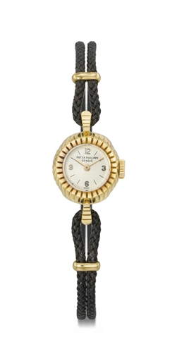 Patek Philippe. A lady's fine and rare 18K gold wristwatch with textured bezel and lugs