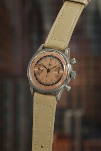 Omega Follow;Ref. CK 2077-3;A highly attractive and rare stainless steel chronograph wristwatch with salmon dial, mirrored black telemeter ring, and red tachymeter scale.