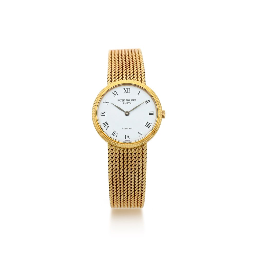 PATEK PHILIPPE | REFERENCE 4819/5 RETAILED BY TIFFANY CO.: A YELLOW GOLD BRACELET WATCH, MADE IN 1985