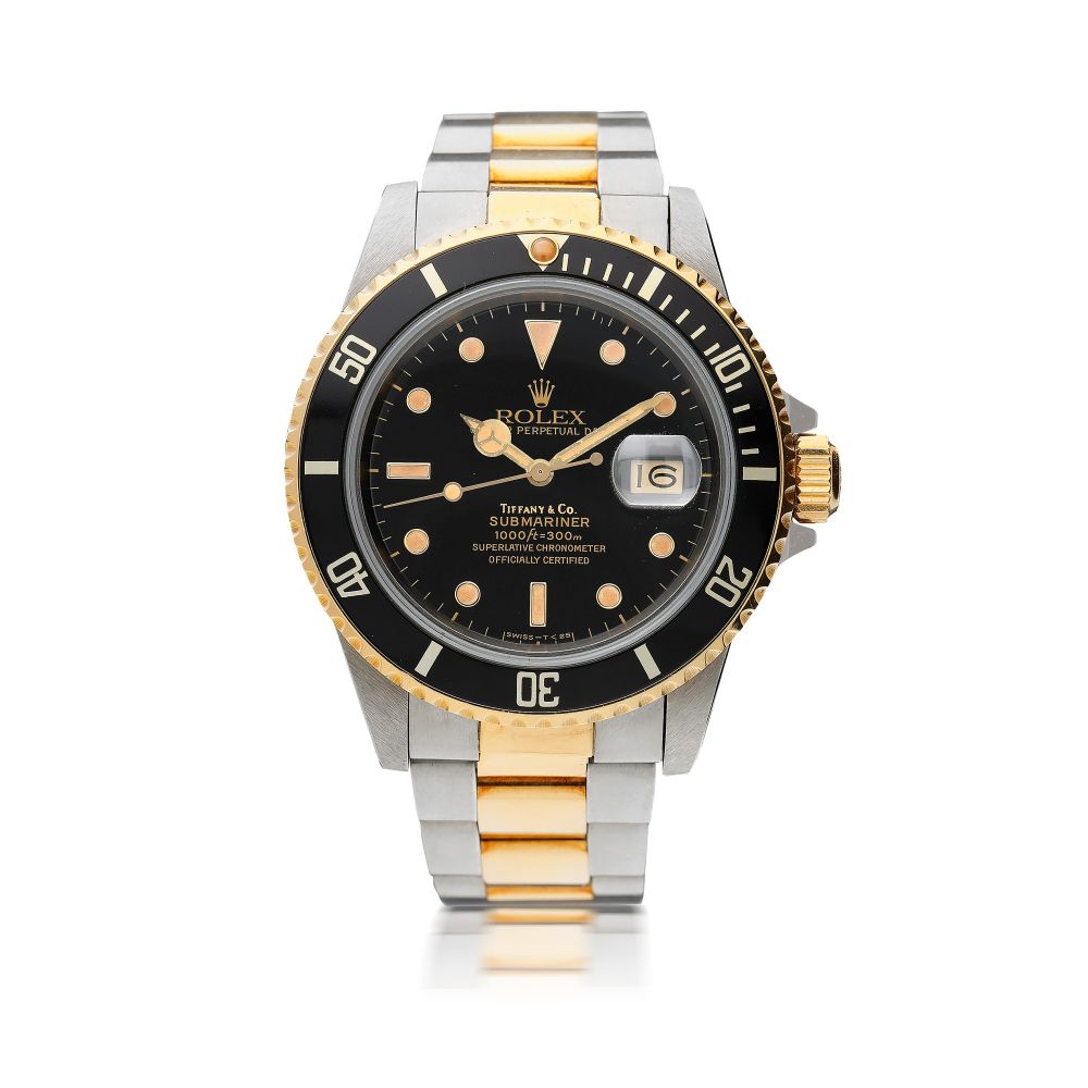 ROLEX | REFERENCE 16803 SUBMARINER RETAILED BY TIFFANY CO.: A STAINLESS STEEL AND YELLOW GOLD AUTOMATIC CENTER SECONDS WRISTWATCH WITH DATE AND BRACELET, CIRCA 1986