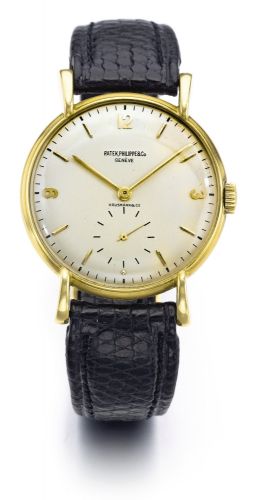 Patek Philippe RETAILED BY HAUSMANN CO.: A FINE YELLOW GOLD MANUALLY WINDING WRISTWATCH REF 1543 MVT 963816 CASE 653580