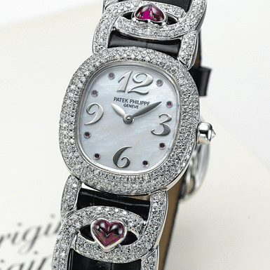 PATEK PHILIPPE, A LADY'S WHITE GOLD AND RUBY SET OVAL WRISTWATCH WITH MOTHER-OF-PEARL DIAL AND LATER ADDED DIAMONDS GOLDEN ELLIPSE, CIRCA 1998,&&NBSP - REF. 4833/12