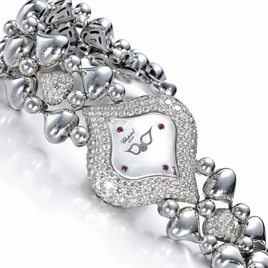CHOPARD, A LADY'S WHITE GOLD AND DIAMOND SET BRACELET WATCH WITH MOTHER-OF-PEARL DIAL CIRCA 2005