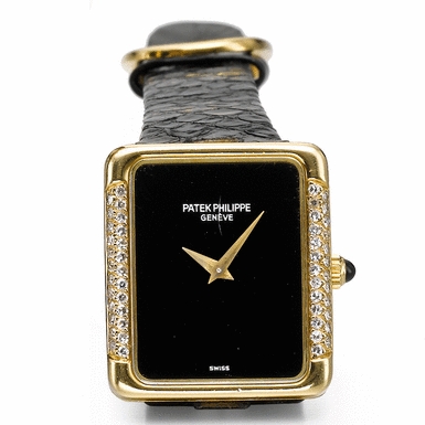 PATEK PHILIPPE - A LADY'S YELLOW GOLD AND DIAMOND-SET RECTANGULAR WRISTWATCH WITH BLACK ONYX DIAL CIRCA 1978 REF 4311J MVT 1395134 CASE 2778088