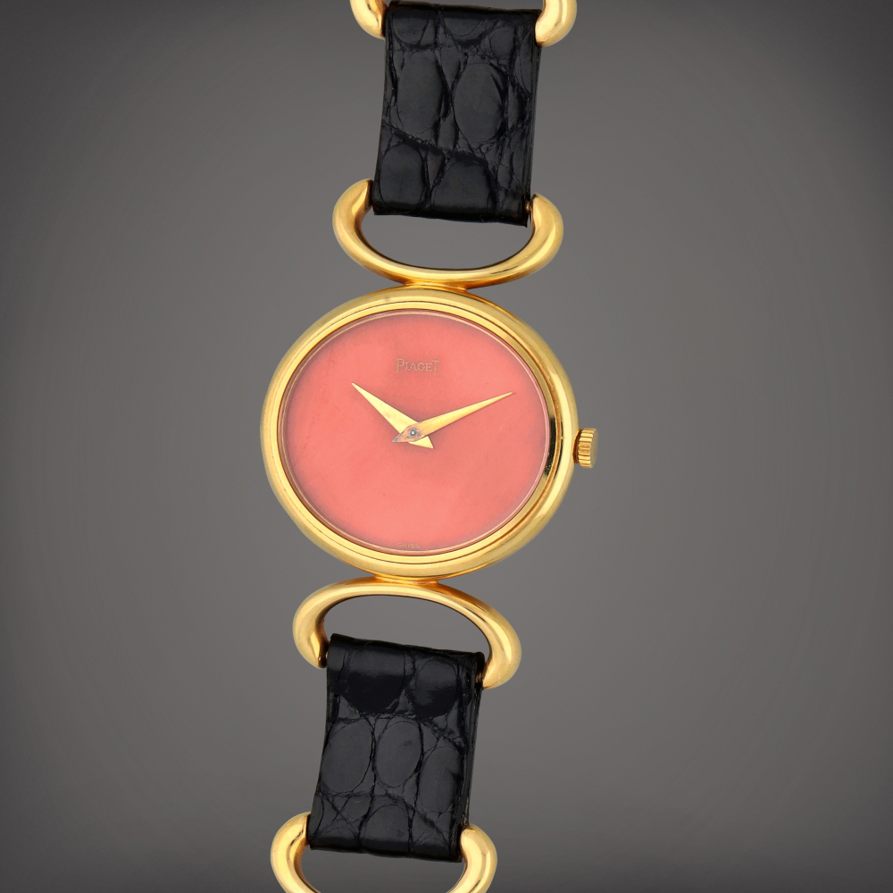 Reference 9802 D | A yellow gold bracelet watch with coral dial | Circa 1970
