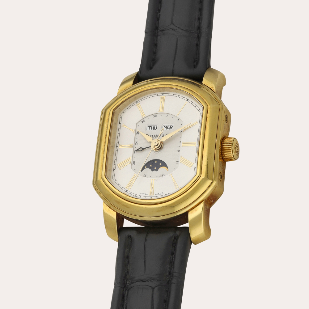 Tiffany Co. A yellow gold triple calendar wristwatch with moon phases | Circa 1990