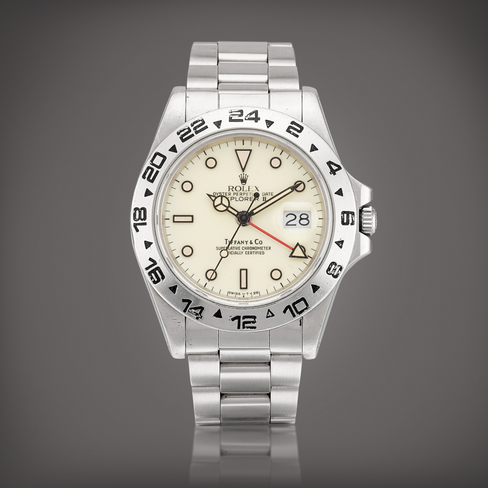 PROPERTY FROM AN ESTEEMED COLLECTOR  Rolex  Explorer II, Reference 16550 A stainless steel wristwatch with 24 hours indication, date, cream dial and bracelet, Retailed by Tiffany Co., Circa 1987 