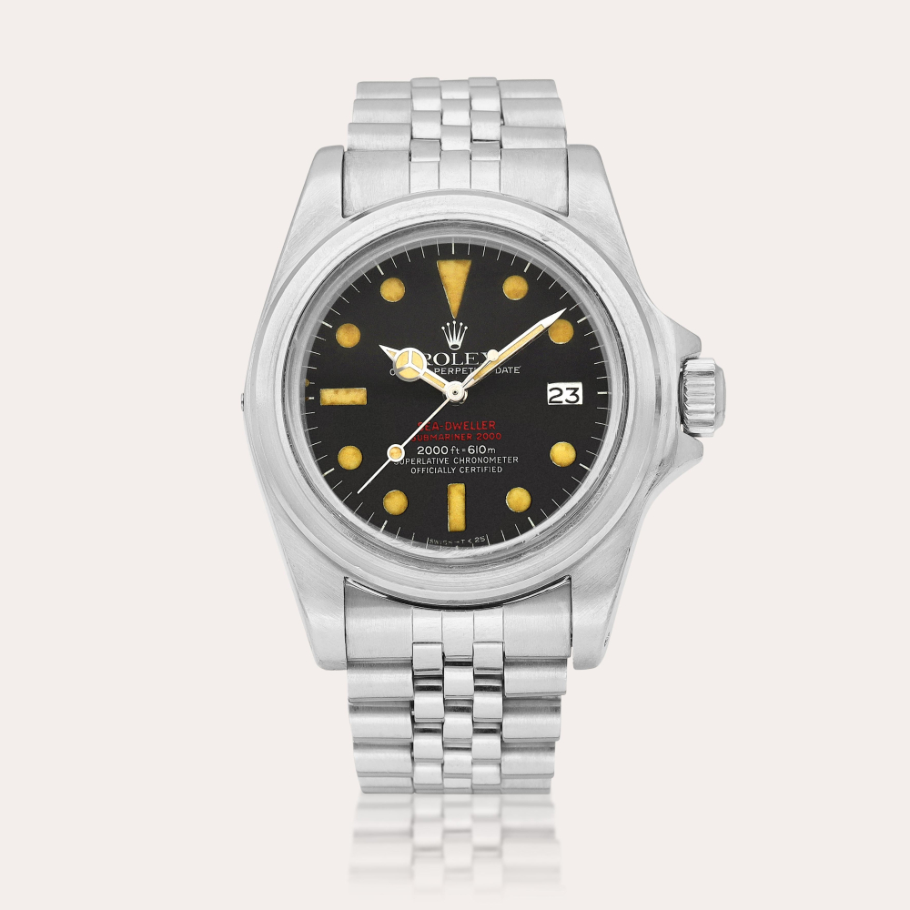 Rolex Sea-Dweller "Double Red", Reference 1665 A stainless steel wristwatch with date and bracelet, Circa 1978｜勞力士｜Sea-Dweller "Double Red" 型號1665｜精鋼鏈帶腕錶，備日期顯示，約1978年製