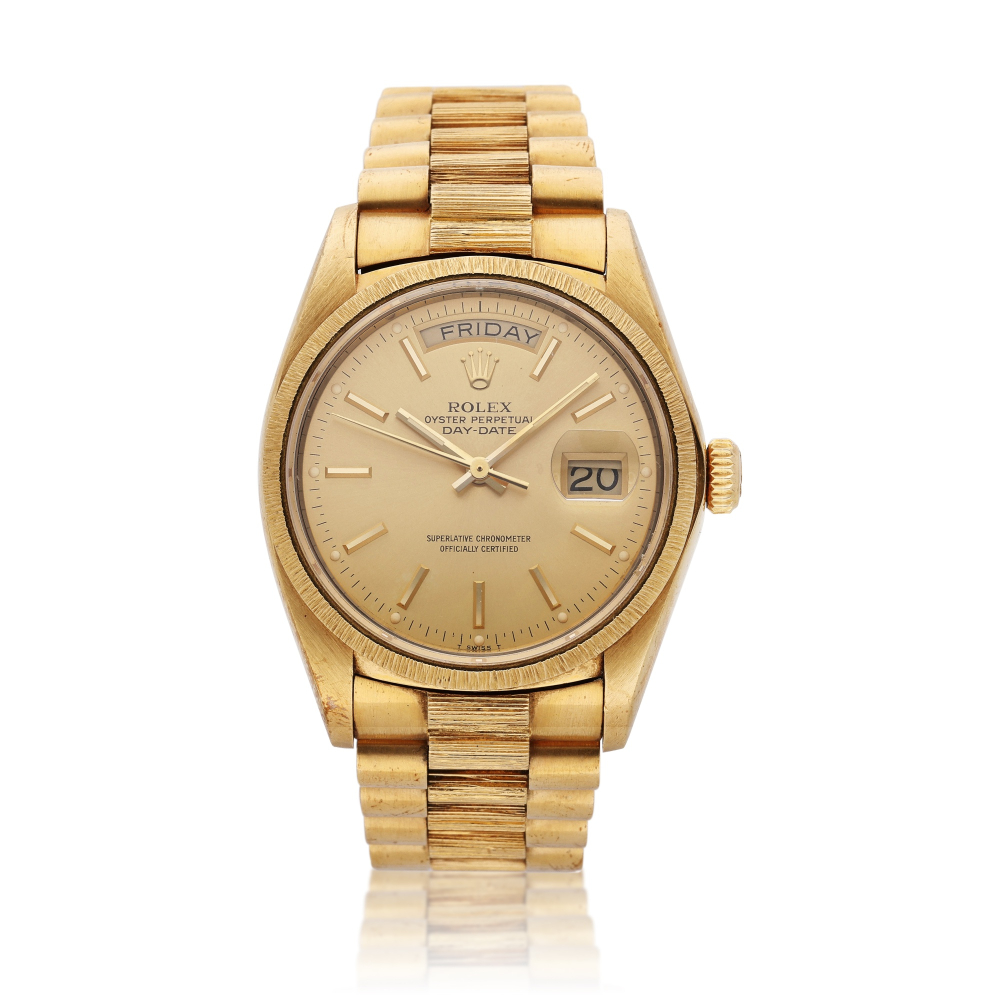 Reference 18078 Day-Date | A yellow gold wristwatch with day, date, bark bezel, and bracelet, Circa 1979
