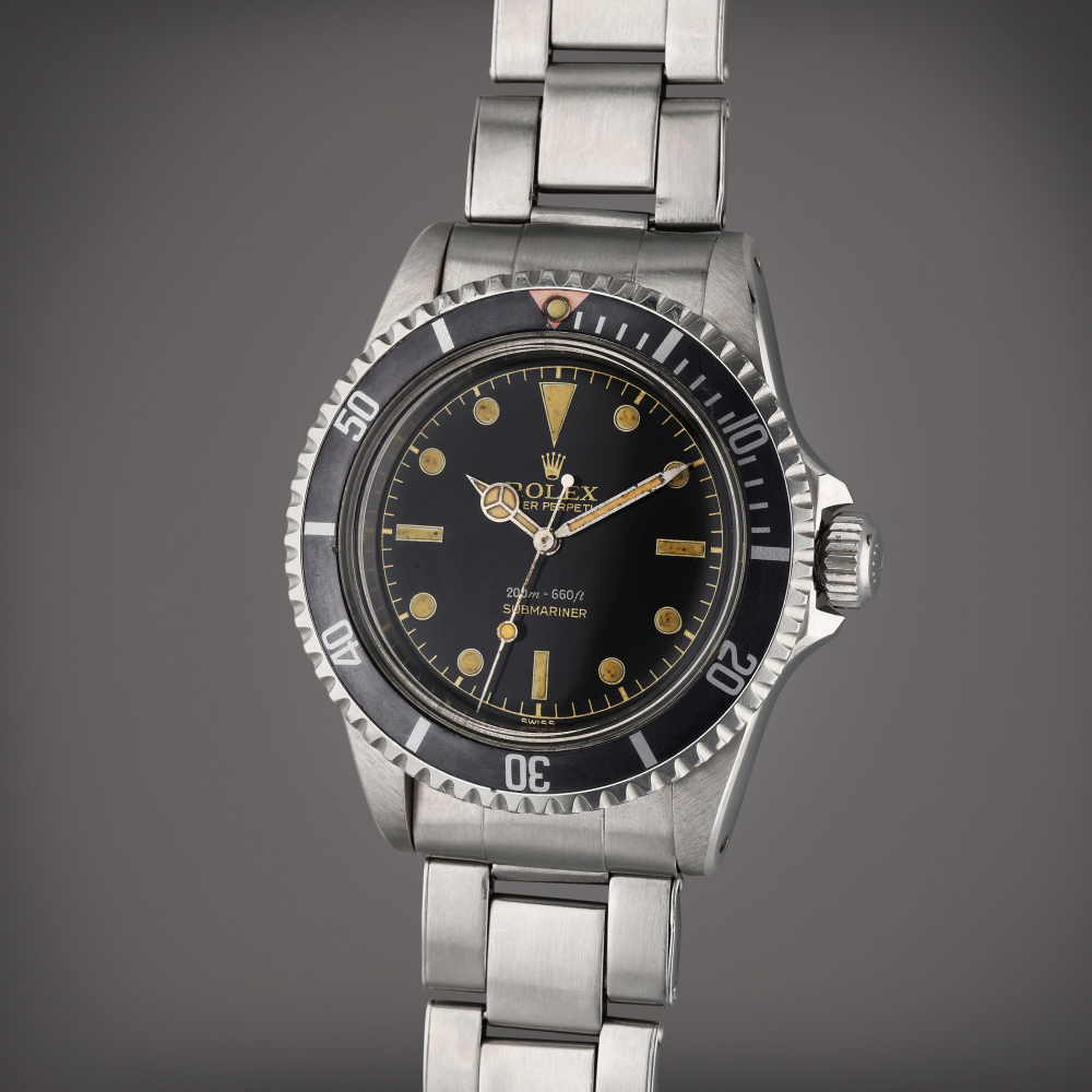 Reference 5512 Gilt Submariner "Eagle Beak" | A stainless steel automatic center seconds wristwatch with pointed crown guards and red triangle bezel insert, Circa 1959