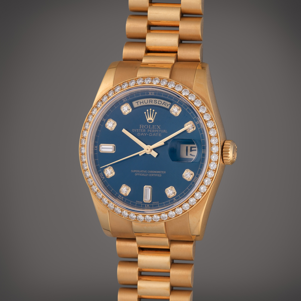 Rolex Reference 118348 Day-Date | A yellow gold and diamond-set automatic wristwatch with day, date, and bracelet, Circa 2003