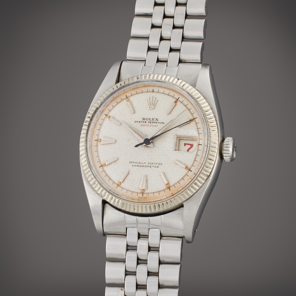 Rolex Reference 6305 1 Datejust | A stainless steel automatic wristwatch with date, bracelet, and red date wheel, Circa 1953