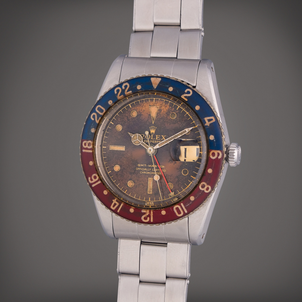 Rolex Reference 6542 GMT-Master | A stainless steel automatic dual time wristwatch with roulette date wheel, bracelet, and bakelite bezel, Circa 1959