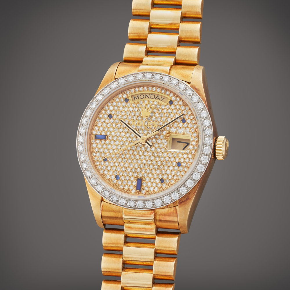 Rolex Reference 18048 Day-Date | A yellow gold and diamond and sapphire-set automatic wristwatch with day, date, and bracelet, Circa 1984