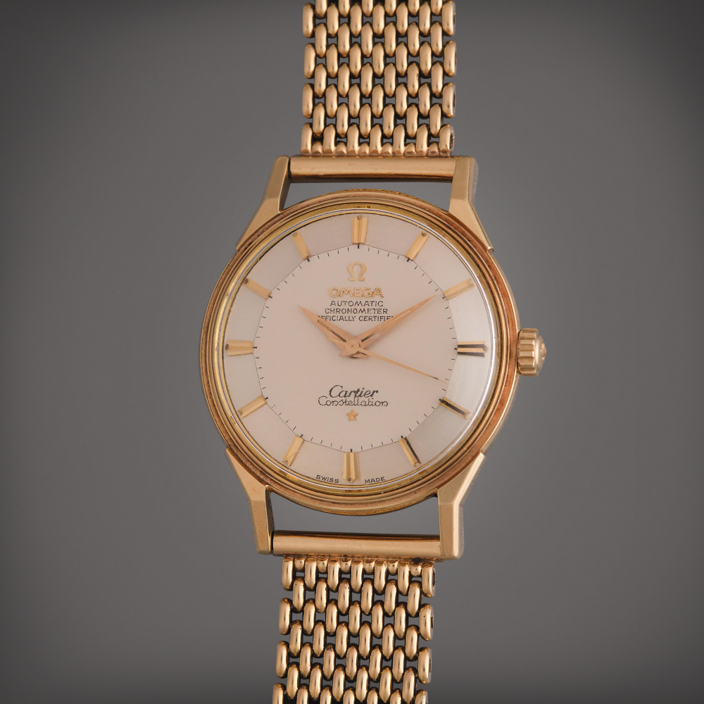 Omega Reference 14900 SC Constellation 'Pie Pan' | Retailed by Cartier: A yellow gold automatic wristwatch with bracelet, Circa 1962