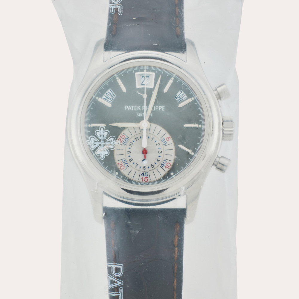 Patek Philippe Reference 5960P-001 | Retailed by Tiffany Co.: A platinum annual calendar flyback chronograph wristwatch with power reserve and day/night indication, Service Sealed, Circa 2013