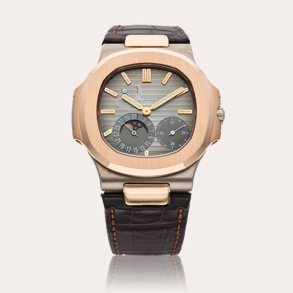 Patek Philippe Reference 5712 Nautilus | A white and pink gold automatic wristwatch with date, moon phases, and power reserve indication, Made in 2011